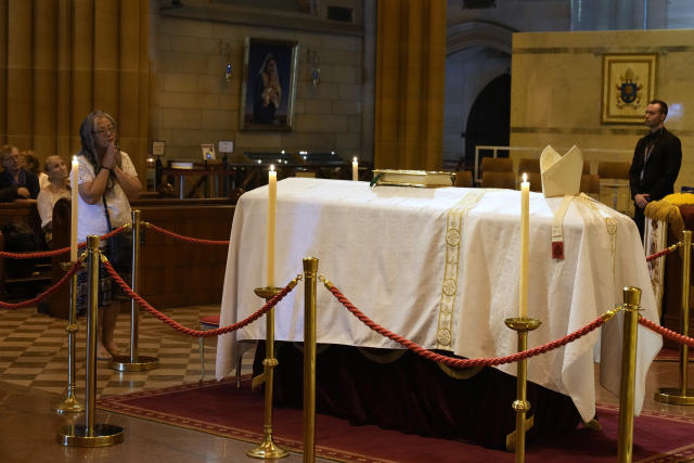 The coffin of Cardinal George Pell lays in state at St. Mary's Cathedral in Sydney, Wednesday, Feb. 1, 2023. Mourners paid their respects to Cardinal George Pell who lay in state in a Sydney cathedral on Wednesday as police sought a court order to prevent protesters from disrupting his funeral. (AP Photo/Rick Rycroft, Pool)