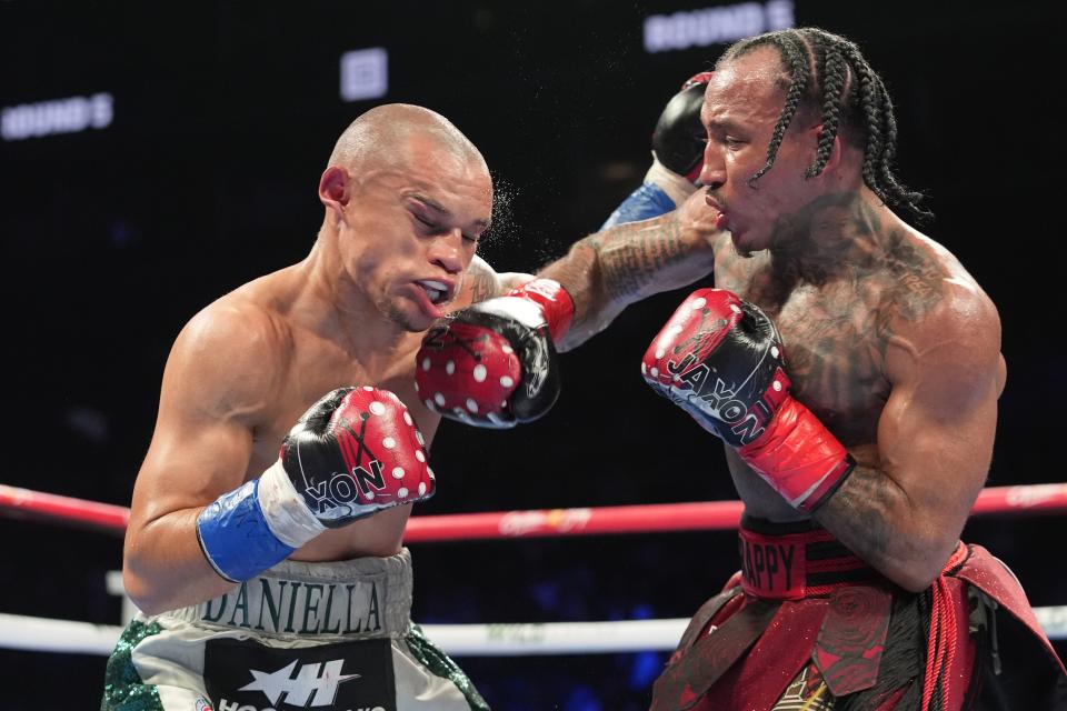 John Ramirez, right, punches Costa Rica's David Jimenez, left, during the fifth round of an interim world super flyweight title boxing match Saturday, April 20, 2024, in New York. Jimenez won the fight. (AP Photo/Frank Franklin II)