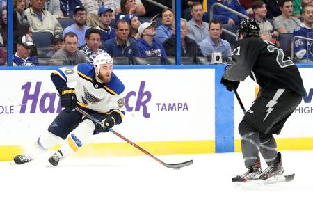 Feb 7, 2019; Tampa, FL, USA; St. Louis Blues center Ryan O'Reilly (90) skates with the puck as Tampa Bay Lightning center Brayden Point (21) defends during overtime at Amalie Arena. St. Louis Blues defeated the Tampa Bay Lightning 1-0. Mandatory Credit: Kim Klement-USA TODAY Sports