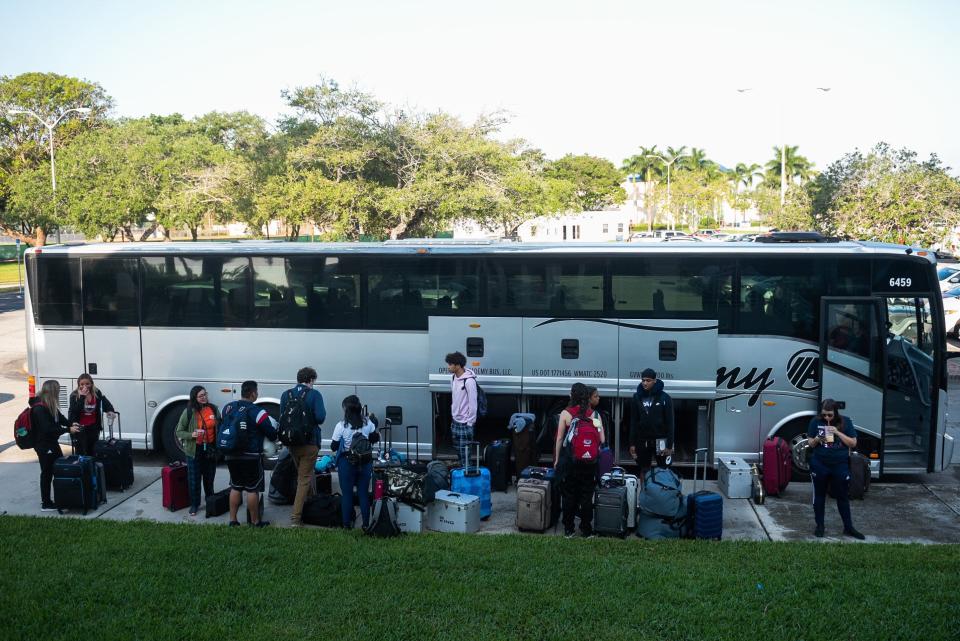 Members of the Florida Atlantic Marching Band load luggage and instruments on to the band bus before departing from Baldwin Arena on Wednesday, March 29, 2023, in Boca Raton, FL. On Wednesday morning, the FAU men's basketball team departed for Houston, Texas, where they will play against San Diego State in the NCAA Tournament semi-final on Saturday.