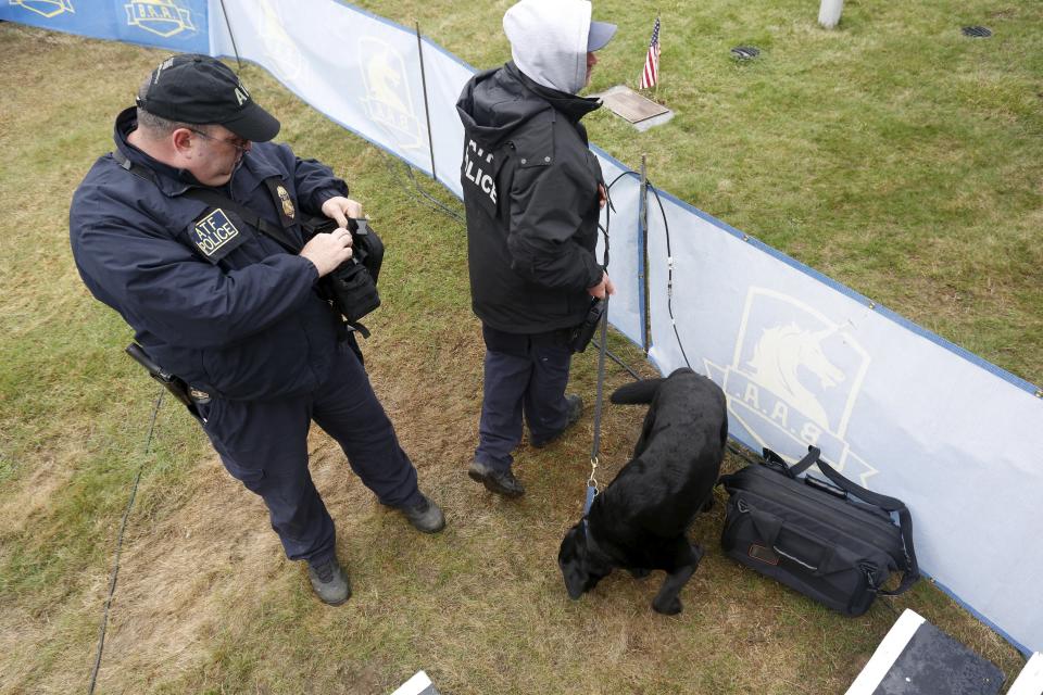 An ATF canine unit inspects a bag near the Boston Marathon start line in Hopkinton