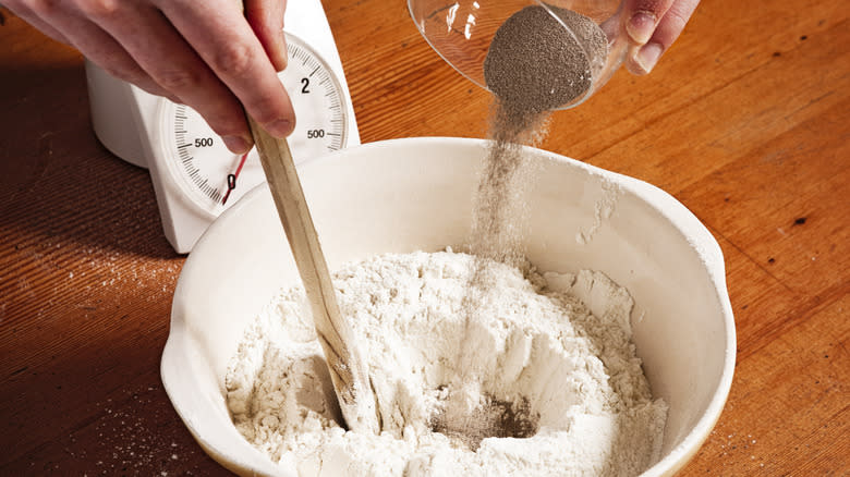 adding yeast to flour