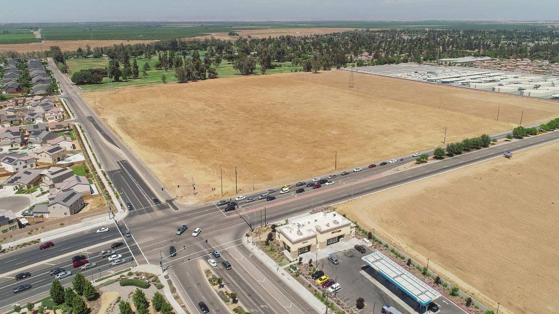 Costco Wholesale is proposing a new store on 22.4 acres of vacant land at the corner of Herndon Avenue and Riverside Drive in northwest Fresno, seen in this drone image looking to the northeast from May 2021. Riverside Golf Course and the San Joaquin River are in the background with a Derrel’s Mini Storage location at upper right.