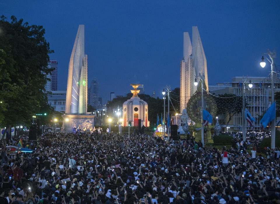 Pro-democracy students hold mobile phones with flashlights switched on in front of Democracy Monument during a rally in Bangkok, Thailand, Sunday, Aug, 16, 2020. A two-day rally planned for this weekend is jangling nerves in Bangkok, with apprehension about how far student demonstrators will go in pushing demands for reform of Thailand’s monarchy and how the authorities might react. More than 10,000 people are expected to attend the Saturday-Sunday event. (AP Photo/Sakchai Lalit)