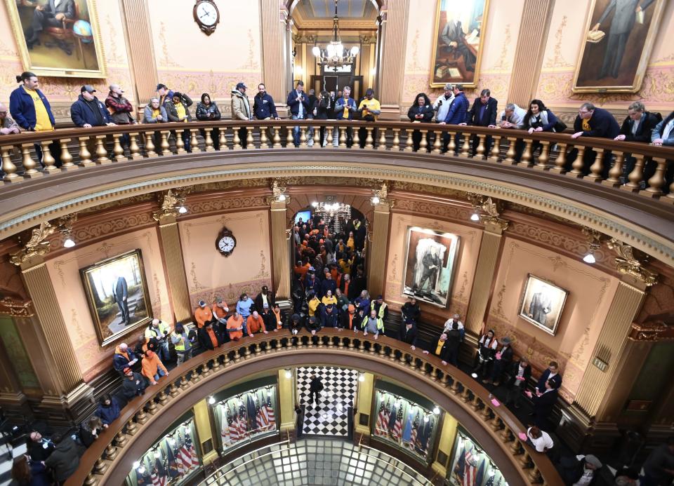 Union members and supporters chant in the Capitol rotunda, Tuesday morning, March 14, 2023, as they wait for a Right To Work bill to be voted on. A Michigan Senate committee voted Tuesday morning to advance bills that would represent landmark victories for labor unions by repealing the 2012 right-to-work law and re-establishing a prevailing wage standard for state projects. (Todd McInturf/Detroit News via AP)