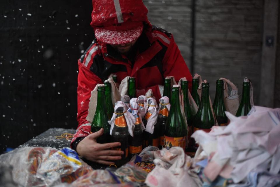 <div class="inline-image__caption"><p>A volunteer demonstrates the preparation of Molotov cocktails at the Pravda brewery in Lviv on Feb. 27, 2022.</p></div> <div class="inline-image__credit">Daniel Leal/AFP via Getty Images</div>