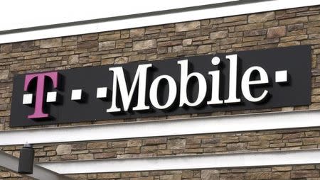 The T-Mobile store sign is seen in Broomfield, Colorado February 25, 2014. REUTERS/Rick Wilking