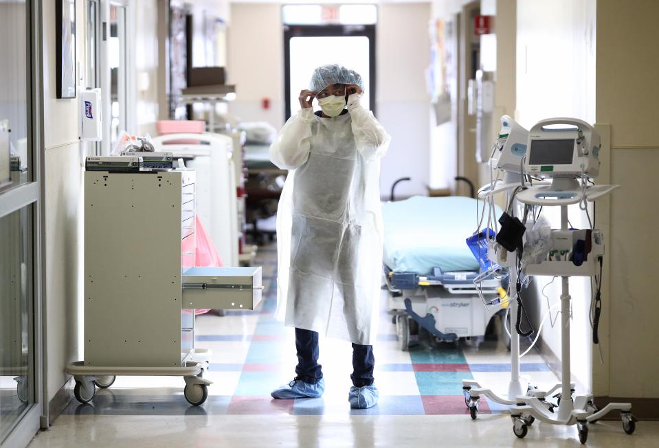 Nurses in the emergency department of MedStar St. Mary's Hospital don personal protective equipment before entering the room of a patient suspected of having coronavirus April 8 in Leonardtown, Md.