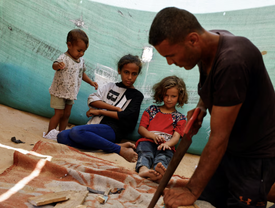 Palestinian Saber Dawas crafts wooden sandals due to a shortage of footwear in the enclave and the lack of financial means to afford those which are available in the market, amid the Israel-Hamas conflict, in Khan Younis in the the southern Gaza Strip, September 9, 2024. REUTERS/Mohammed Salem