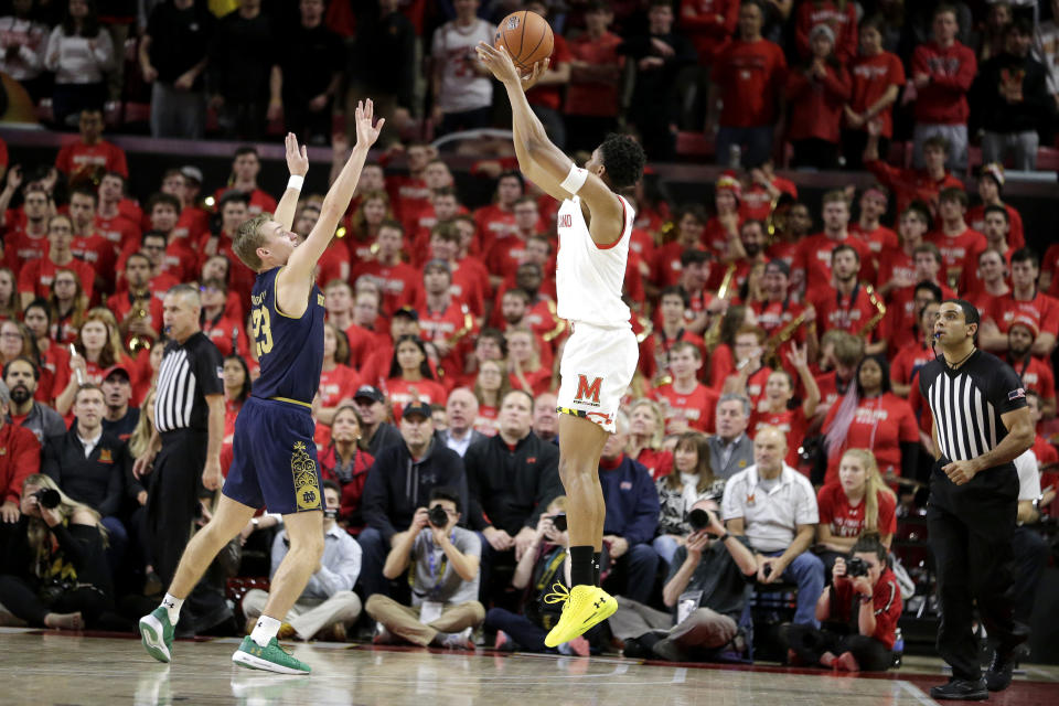 Maryland guard Aaron Wiggins, right, shoots against Notre Dame guard Dane Goodwin during the first half of an NCAA college basketball game, Wednesday, Dec. 4, 2019, in College Park, Md. (AP Photo/Julio Cortez)