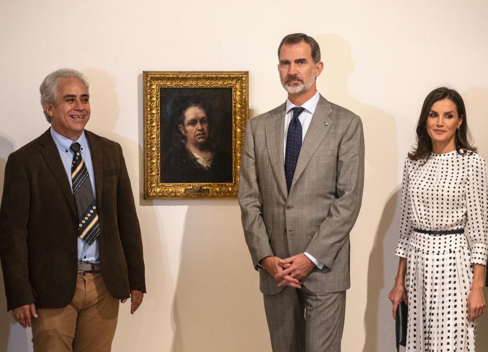 Spain's King Felipe and Queen Letizia pose for photos standing next to a self-portrait of Spanish painter Francisco de Goya, accompanied by the museum director Jorge Fernandez, at the Bellas Artes Museum in Old Havana, Cuba, Thursday, Nov. 14, 2019. (AP Photo/Ramon Espinosa, Pool)