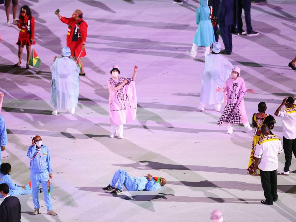 An Eritrean Olympian lays down during the parade of nations.