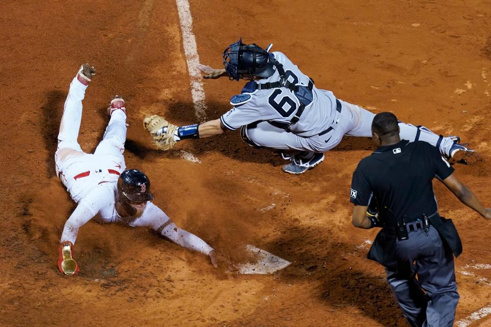 New York Yankees catcher Rob Brantly stretches for the tag but Boston Red Sox's Alex Verdugo is safe at home on a sacrifice fly by Enrique Hernandez during the seventh inning of a baseball game at Fenway Park, Thursday, July 22, 2021, in Boston. (AP Photo/Elise Amendola)