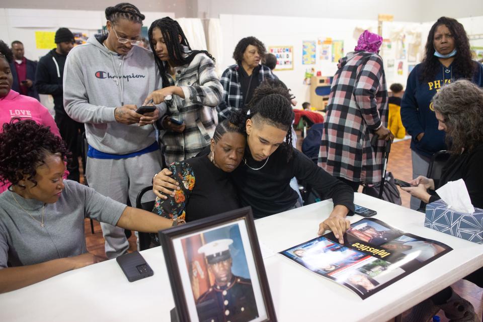 Christopher Kelley's sister Christian Kelley and son Isaiah Kelley sit together following Sunday's news conference.