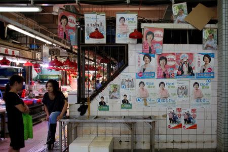 Candidates' campaign posters for the Legislative Council election are displayed at a market in Hong Kong, China August 17, 2016. Picture taken August 17, 2016. REUTERS/Bobby Yip