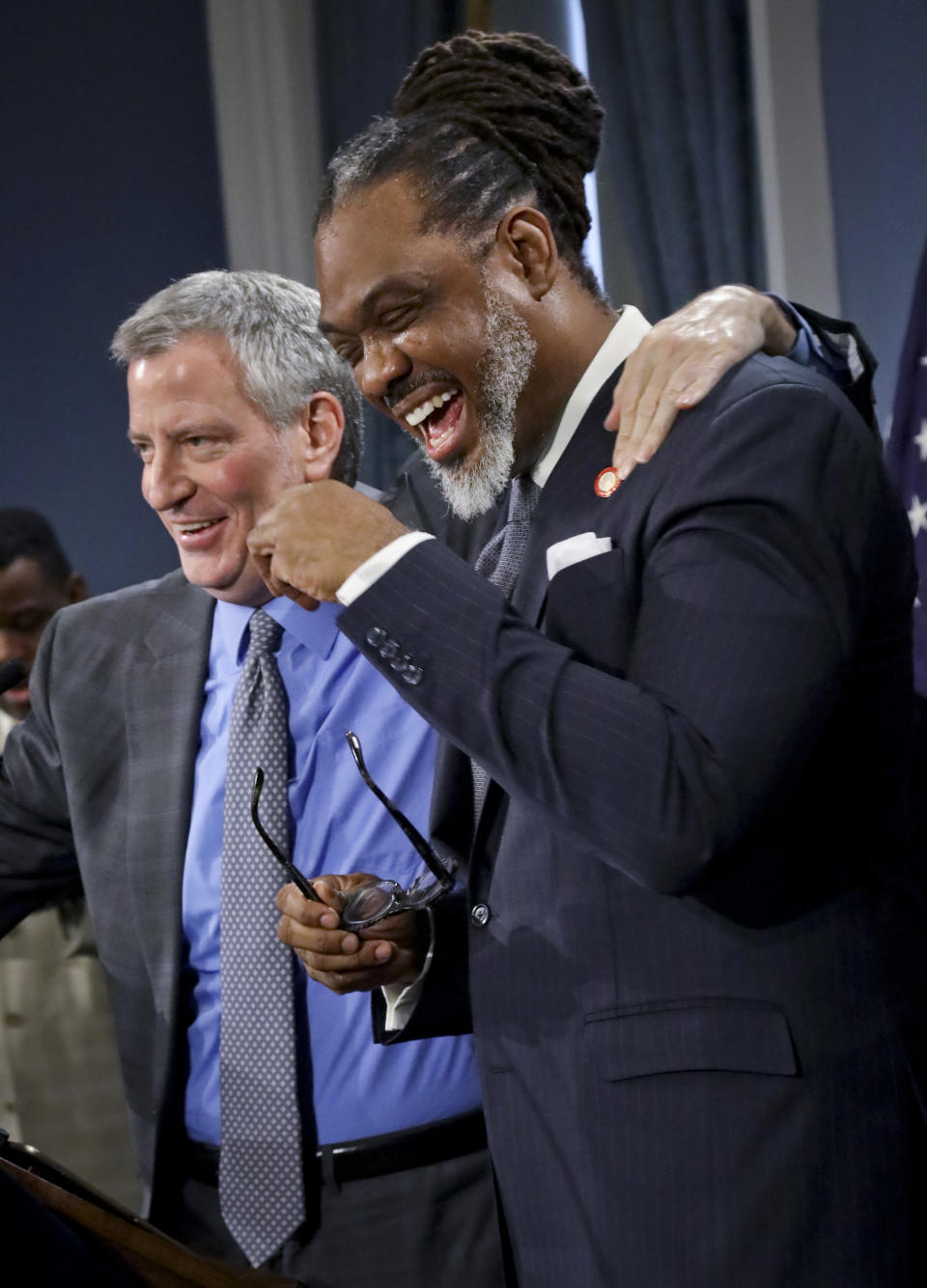 New York Mayor Bill de Blasio, left, share tall jokes humor with N.Y. City Councilman Robert Cornegy, Jr. after awarding him the Guinness World Record's prize for tallest male politician, Wednesday March 27, 2019, at City Hall in New York. (AP Photo/Bebeto Matthews)
