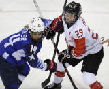 Brianna Decker of U.S. and Marie-Philip Poulin of Canada in action. REUTERS/David W Cerny