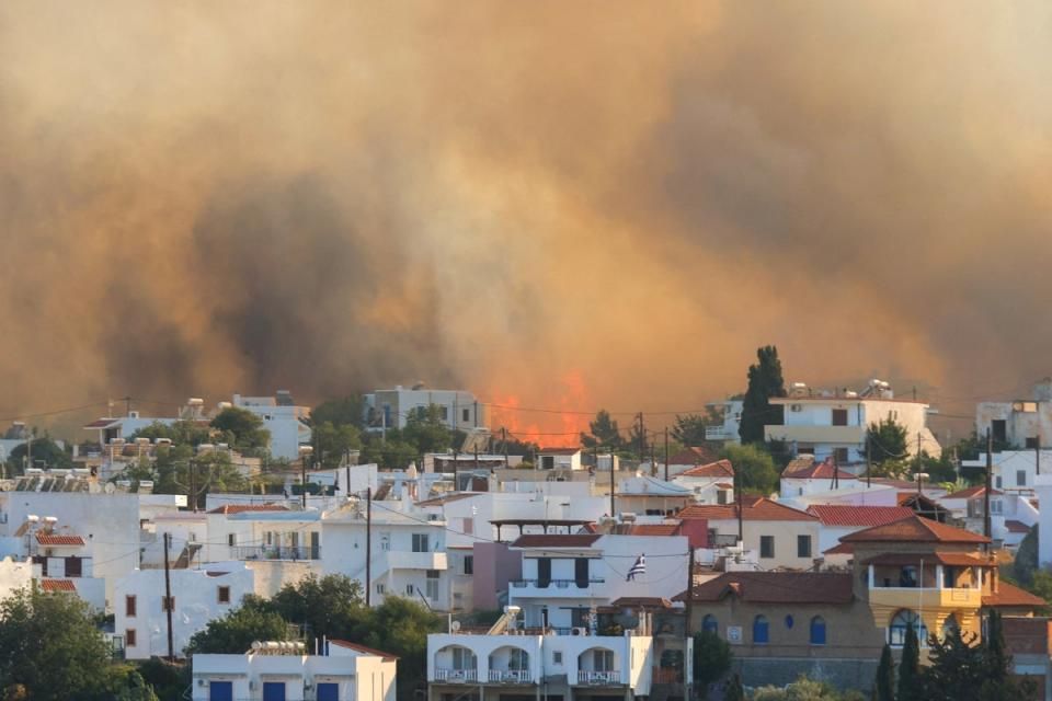 Flames and smoke rise as a wildfire burns near the village of Gennadi, on the island of Rhodes, Greece (Reuters)