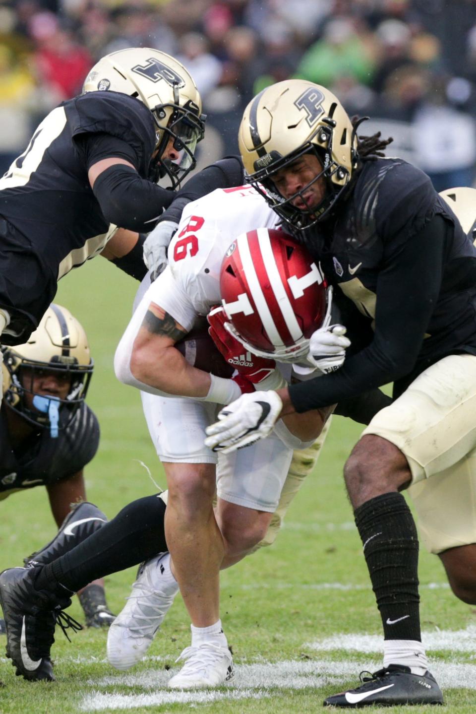 Purdue safeties Cam Allen (10) and Marvin Grant (4) stop Indiana tight end Peyton Hendershot (86) during the first quarter of a football game on Nov. 27, 2021 at Ross-Ade Stadium in West Lafayette, Indiana. Grant has since transferred to join the Kansas Jayhawks.