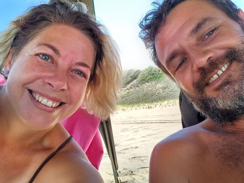 The author and her partner on a beach.