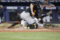 Miami Marlins' Billy Hamilton, rear, scores against Pittsburgh Pirates catcher Jason Delay during the fifth inning of a baseball game, Thursday, July 14, 2022, in Miami. (AP Photo/Wilfredo Lee)