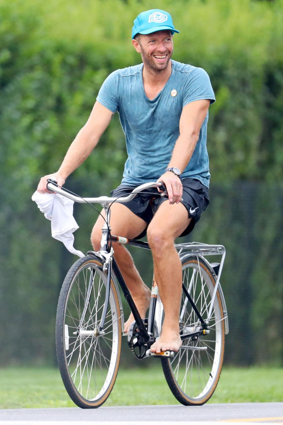 <p>Chris Martin goes for a barefoot bike ride through The Hamptons, New York on Wednesday.</p>