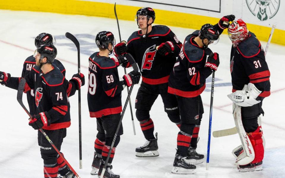 Carolina Hurricanes center <a class="link " href="https://sports.yahoo.com/nhl/players/7901/" data-i13n="sec:content-canvas;subsec:anchor_text;elm:context_link" data-ylk="slk:Jesperi Kotkaniemi;sec:content-canvas;subsec:anchor_text;elm:context_link;itc:0">Jesperi Kotkaniemi</a> (82) congratulates goalie Frederik Anderson (31)following their 6-3 victory over the New York Islanders in Game 5 of the NHL Eastern Conference quarterfinals on Tuesday, April 30, 2024 at PNC Arena in Raleigh N.C. Robert Willett/rwillett@newsobserver.com