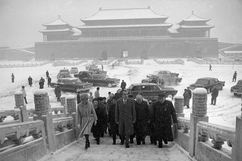 FILE - Then U.S. President Richard Nixon and first lady Pat Nixon enter the palace grounds of Beijing's Forbidden City as heavy snow falls on Feb. 25, 1972. At the height of the Cold War, U.S. President Richard Nixon flew into communist China's center of power for a visit that over time would transform U.S.-China relations and China's position in the world in ways that were unimaginable at the time. (AP Photo, File)