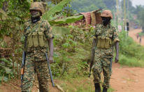 Soldiers patrol outside opposition challenger Bobi Wine's home in Magere, Kampala, Uganda, Saturday, Jan. 16, 2021, after President Yoweri Museveni was declared the winner of the presidential election. Uganda’s electoral commission says longtime President Yoweri Museveni has won a sixth term, while top opposition challenger Bobi Wine alleges rigging and officials struggle to explain how polling results were compiled amid an internet blackout. In a generational clash widely watched across the African continent, the young singer-turned-lawmaker Wine posed arguably the greatest challenge yet to Museveni. (AP Photo/Nicholas Bamulanzeki)