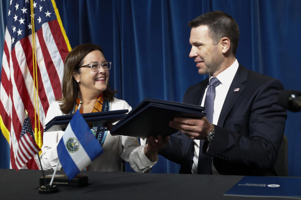 Acting Secretary of Homeland Security Kevin McAleenan exchanges folders with El Salvador Foreign Affairs Minister Alexandra Hill after signing an agreement during news conference at the U.S. Customs and Border Protection headquarters in Washington, Friday, Sept. 20, 2019. (AP Photo/Pablo Martinez Monsivais)