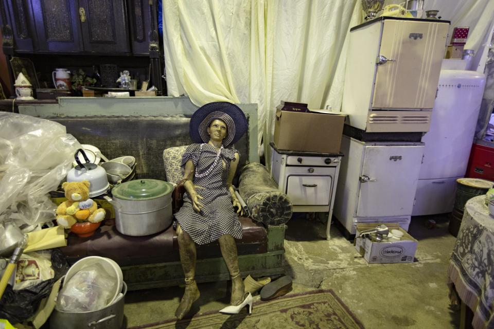 In this photo taken on Sunday, Nov. 3, 2019, a mannequin of a woman surrounded by Soviet era style articles in an apartment are on display in the 'Museum of Industrial Culture' in a dilapidated industrial zone of Moscow, Russia.Moscow’s suburbs are the focus of a major international art exhibition that has just opened in the Russian capital. The exhibit uses contemporary art to explore the many hidden facets of life beyond the Russian capital’s nucleus. Austrian cultural attache says the ‘real’ Moscow where most of the city’s 12.6 million people live, is outside the center. (AP Photo/Alexander Zemlianichenko)