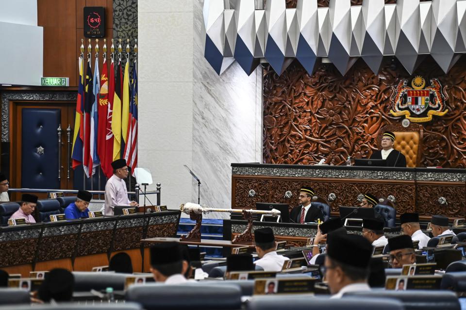 In this photo released by Malaysia's Department of Information, Malaysia's Prime Minister and Finance Minister Anwar Ibrahim delivers his 2024 budget speech at the Parliament in Kuala Lumpur, Malaysia, Friday, Oct. 13, 2023. (Malaysia's Department of Information via AP)