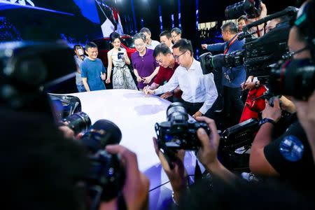 Jack Ma (L), Alibaba's founder and chairman, and other company leaders attend the launch event of a internet-connected car in Hangzhou, Zhejiang province, July 6, 2016. China Daily/via REUTERS