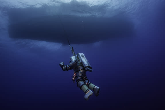 WHOI's diving safety officer Edward O'Brien pilots the Exosuit, suspended from the Hellenic Navy vessel THETIS. This one-of-a-kind diving outfit could eventually help underwater archaeologists explore deep sunken ships like the Antikythera wrec