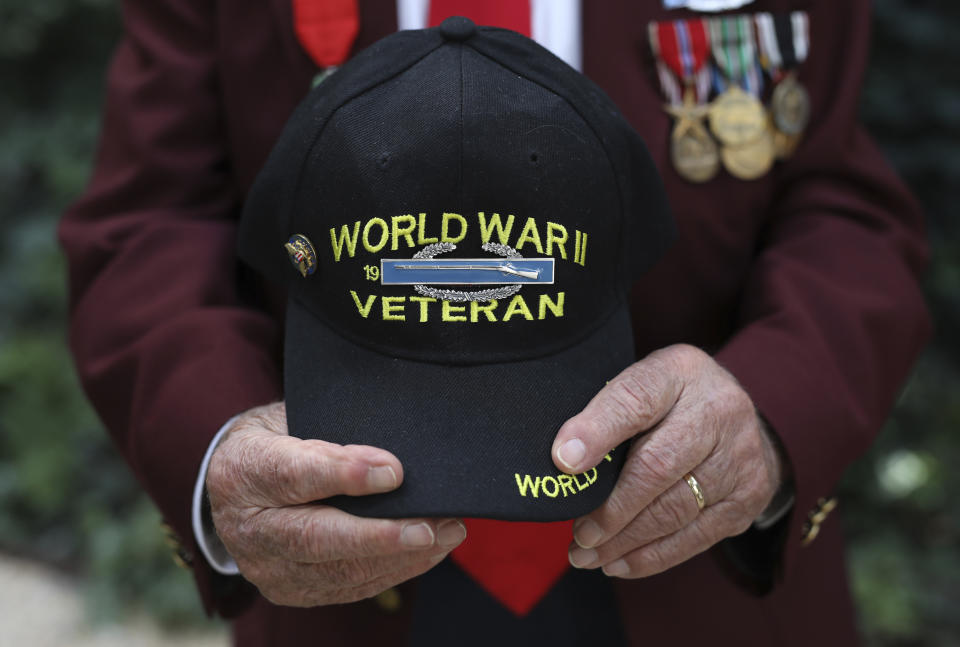 Harold Radish, 95, of the 90th division and a prisoner of war, holds his cap during an interview with the Associated Press Friday, Aug.23, 2019 in Paris. Radish arrived in Normandy a few months after D-Day, fought into Germany, and then was captured and held as a prisoner of war. As a Jew, he remains surprised and grateful to have made it out alive. Radish was part of a group of World War II veterans taking part in commemorations of the 75th anniversary of the Allied operation to liberate Paris from Nazi occupation. (AP Photo/Daniel Cole)