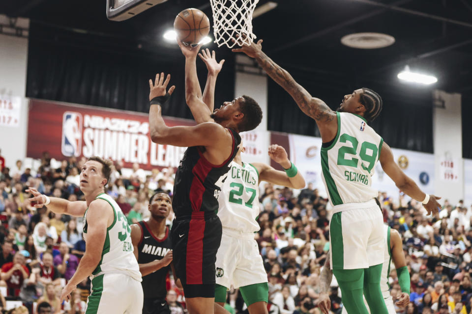 Miami Heat center Orlando Robinson, center front, makes a basket as Boston Celtics guard Jay Scrubb (29) tries to keep him from the net during an NBA Summer League basketball game Saturday, July 8, 2023, in Las Vegas. (Madeline Carter/Las Vegas Review-Journal via AP)