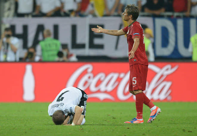 Portuguese defender Fabio Coentrao (L) gestures after fouling German midfielder Bastian Schweinsteiger (L) during the Euro 2012 championships football match Germany vs Portugal on June 9, 2012 at the Arena Lviv. AFP PHOTO / JEFF PACHOUDJEFF PACHOUD/AFP/GettyImages