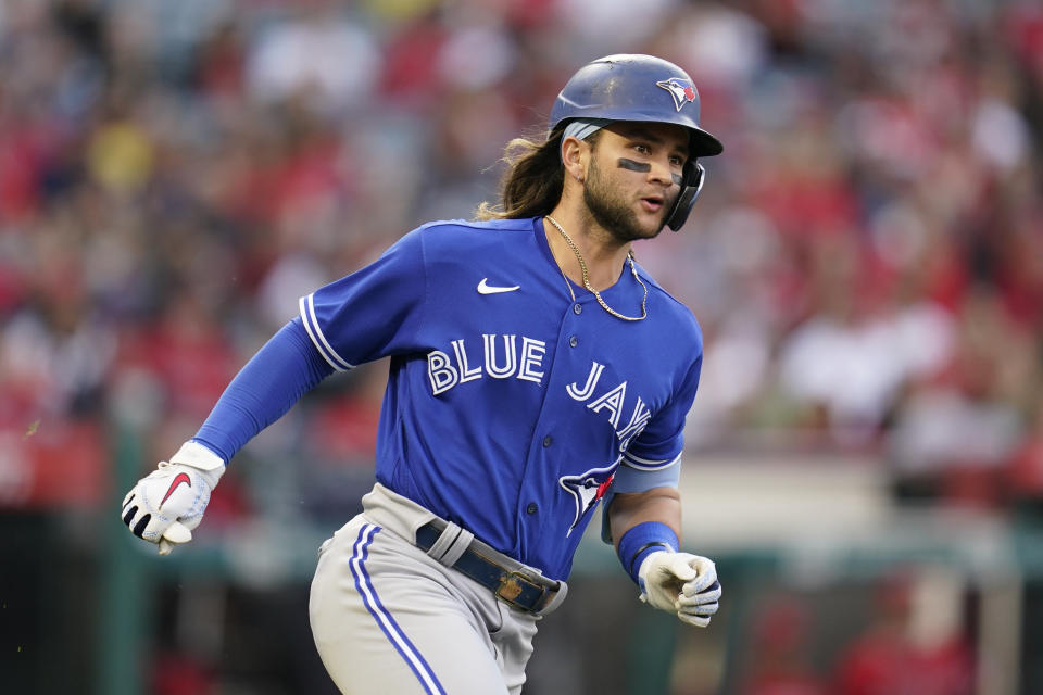 Toronto Blue Jays' Bo Bichette (11) runs to second base on a ground-rule double during the second inning of a baseball game against the Los Angeles Angels in Anaheim, Calif., Friday, May 27, 2022. (AP Photo/Ashley Landis)