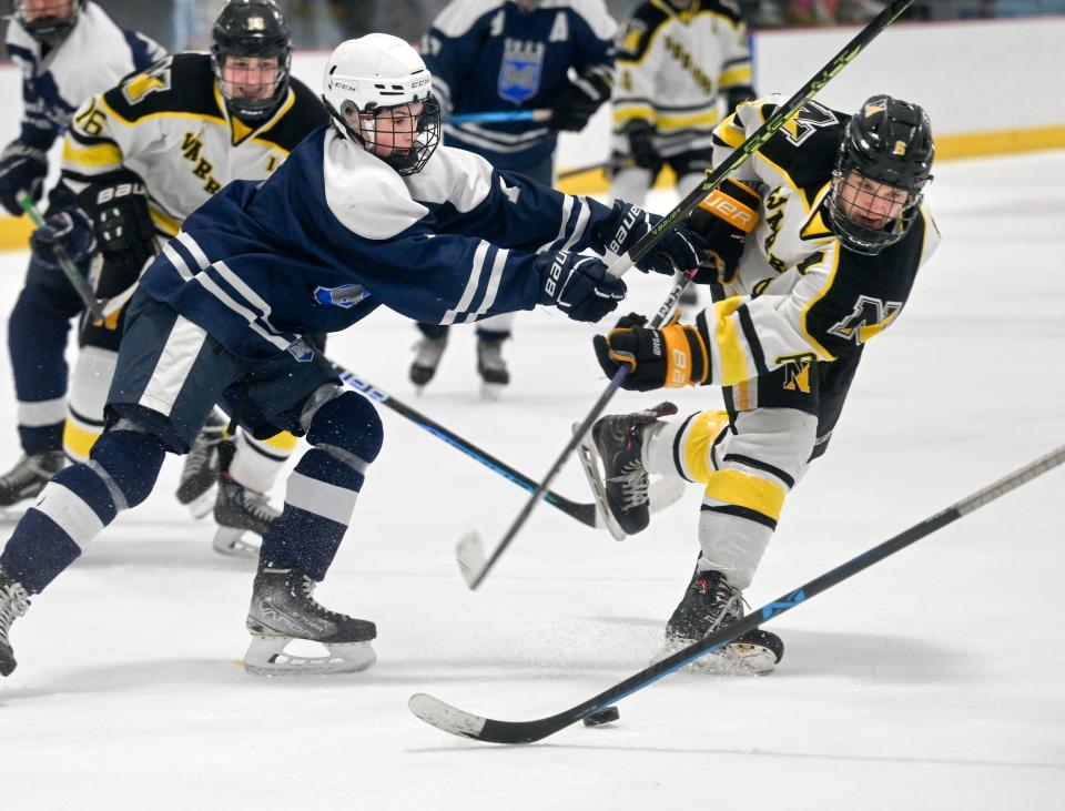 Dan Deering of Nauset puts a shot on the Mashpee/Monomoy goal defended by Gavin O'Leary during a Feb. 20th game.