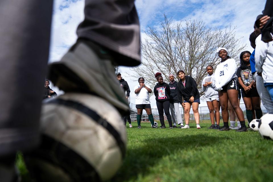 The North High girls soccer team huddles before their practice on April 18 in Des Moines.