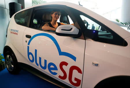 Marie Bollore, managing director of Blue Solutions poses in a BlueSG electric car-sharing vehicle during their launch in Singapore December 12, 2017. REUTERS/Edgar Su