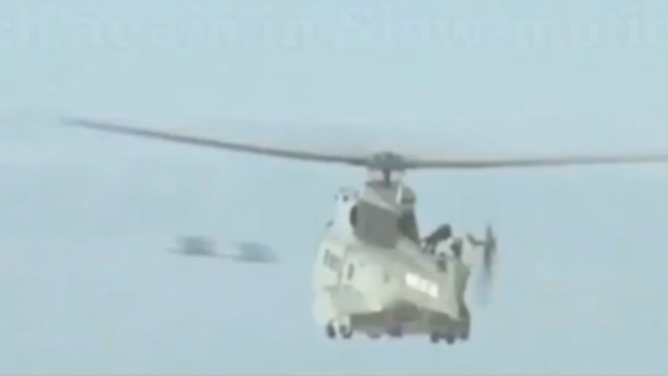 Two objects are seen approaching a helicopter. Photo: Youtube