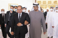 This photo provided by the Ministry of Presidential Affairs, shows Egyptian President Abdel Fattah El Sisi, center left, walking with Sheikh Mohamed bin Zayed Al Nahyan, the new President of the United Arab Emirates, on his arrival to offer offers condolences on the death of Sheikh Khalifa bin Zayed Al Nahyan, the late President of the UAE, at the Presidential Airport in Abu Dhabi, UAE, Saturday, May 14, 2022. An array of presidents and prime ministers continued to descend on the UAE Sunday from around the world to pay their respects to the federation's late ruler and greet his successor — a vivid sign of Abu Dhabi's influence in Western and Arab capitals. (Mohamed Al Hammadi/Ministry of Presidential Affairs via AP)