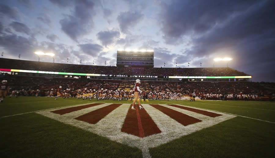 The Iowa State NCAA college football football team warms up as a logo of the Jack Trice era is displayed at the center of the field to commemorate the 100th anniversary of Trice’s death, before Iowa State and TCU played in the Jack Trice Legacy game at Jack Trice Stadium, Saturday, Oct. 7, 2023, in Ames, Iowa. (Nirmalendu Majumda/Ames Tribune via AP)