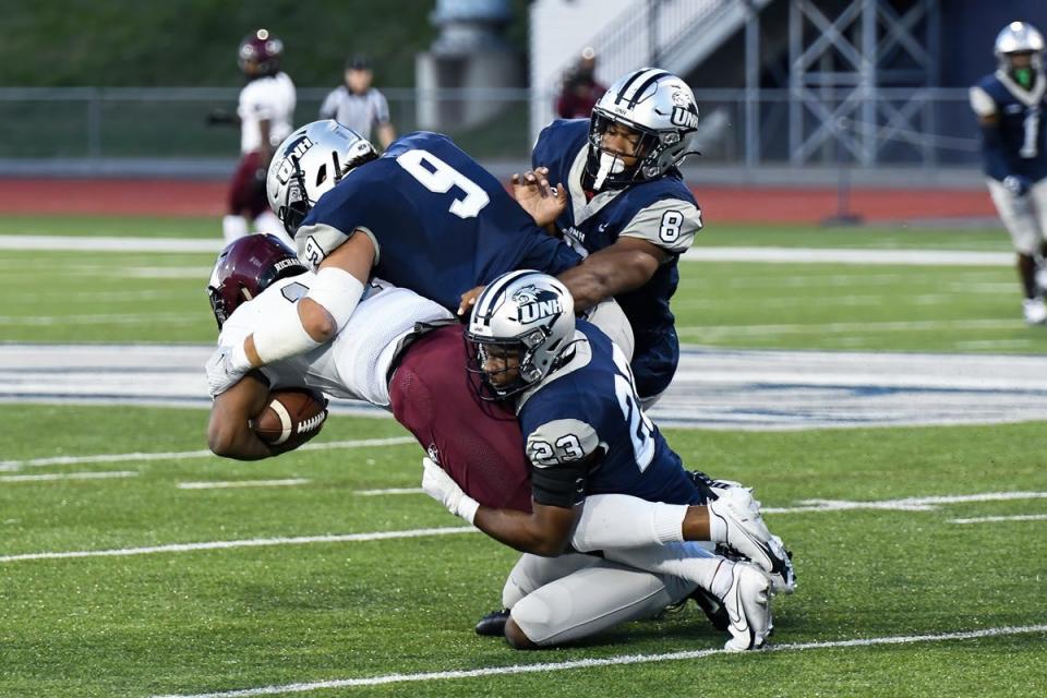 University of New Hampshire's defense takes down a North Carolina Central player Sept. 17, 2022 in Durham.