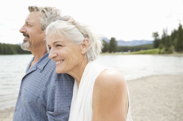 Affectionate mature couple walking on the beach