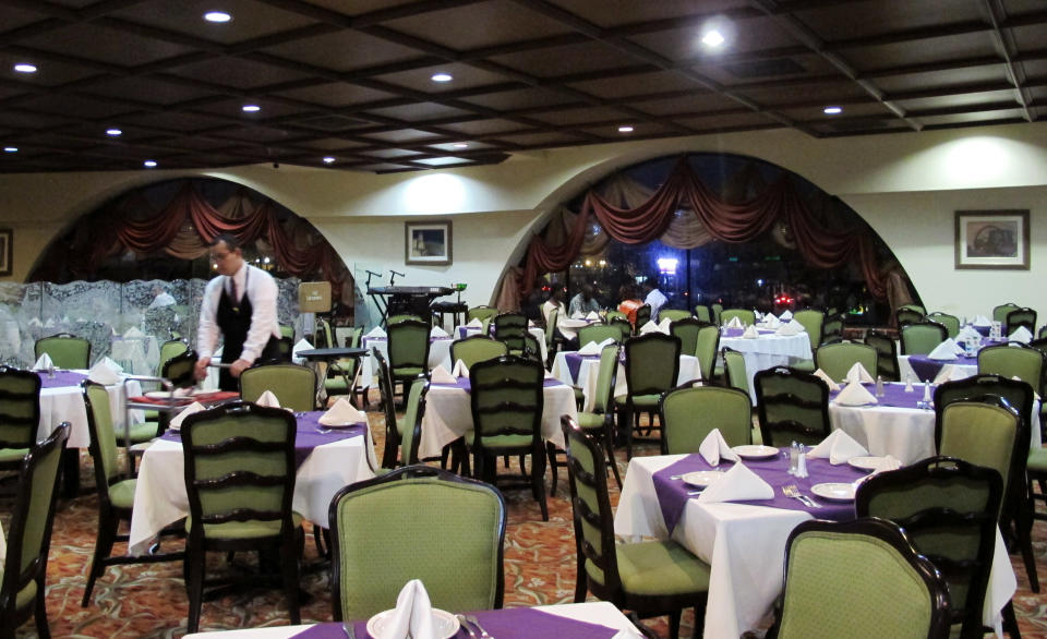 This Friday, Feb. 28, 2014 photo shows a waiter in an empty Garcia's Restaurant in Matamoros, Mexico. In the midst of a three-year increase in American tourism in Mexico, communities along the Rio Grande are trying to win back U.S. tourists and revitalize their tourism industry. (AP Photo/Olga Rodriguez)