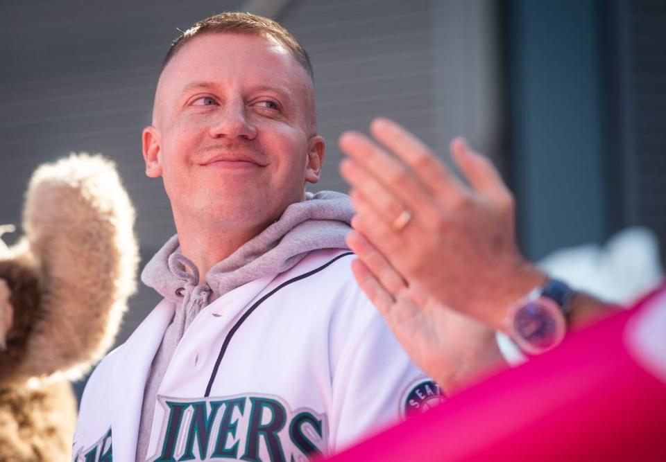 Macklemore smiles as people cheer during a ribbon-cutting ceremony before the game. The Seattle Mariners played the Boston Red Sox in a Major League Baseball game at T-Mobile Park in Seattle, Wash., on Thursday, March 28, 2019.