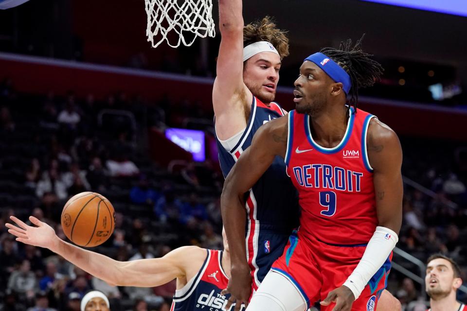 Detroit Pistons forward Jerami Grant passes the ball around Washington Wizards forward Corey Kispert during the first half Friday, March 25, 2022, at Little Caesars Arena in Detroit.