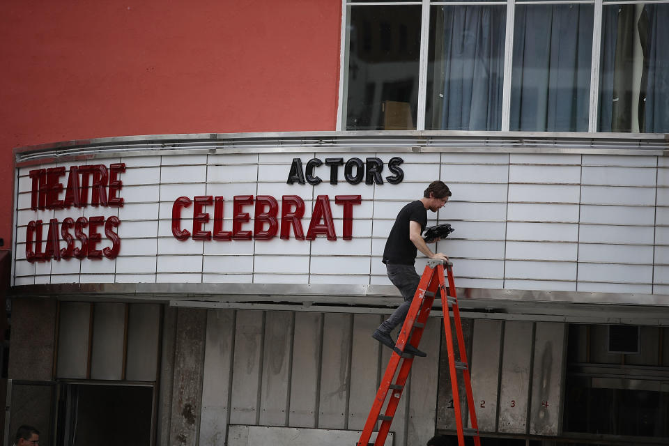 Matt Scally takes the letters of the marquee at the Actors' Playhouse at the Miracle Theatre as they prepare for Hurricane Irma on September 6, 2017 in Miami.